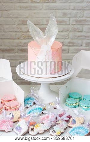 Mermaid Theme Candy Bar With Cake, Cupcakes, Macaroons And Biscuits. Sea Shell Shaped Macaroons With