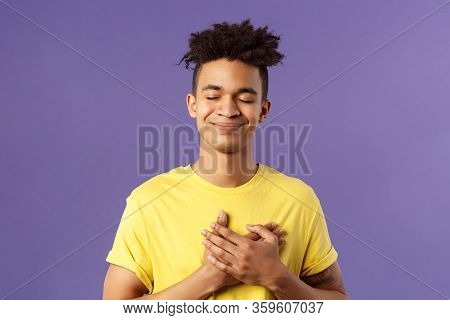 Always In My Heart. Touched, Carefree Handsome Young Man With Dreads, Yellow T-shirt, Close Eyes And