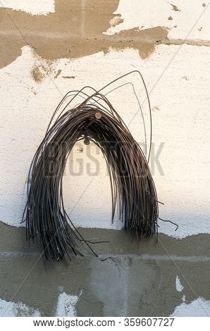 Knitting Wire Hanging On A White Wall