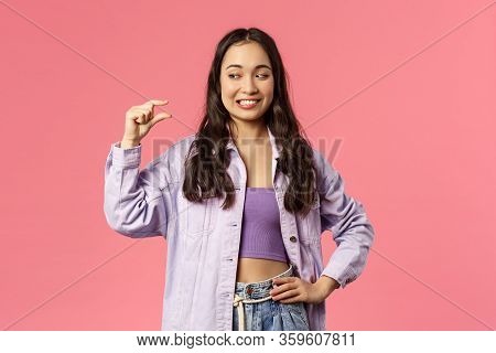 Portrait Of Smiling Awkward Cute Girl, Asian Female Have Little Effort, Show Something Small, Tiny S