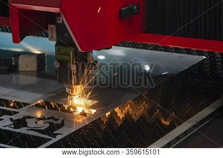 The Fiber Laser Cutting Machine Cutting The Sheet Metal  Plate With The Sparkling Light.  The Hi-tec