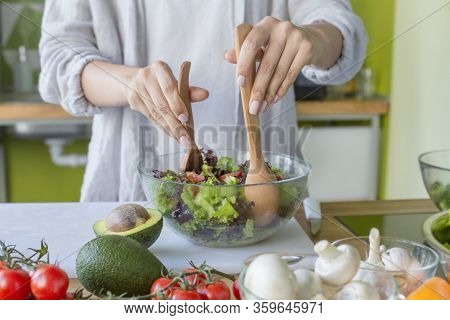 Nutrition. Woman On Healthy Diet Of Organic Green Vegetables Making Salad In Kitchen, Copy Space