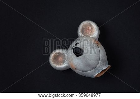 Mouse Head Of A Broken Clay Figure On A Dark Background