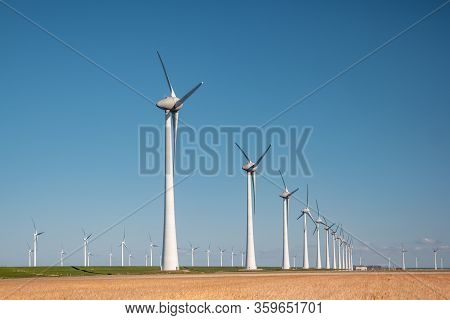 Offshore Windmill Farm In The Ocean Westermeerwind Park , Windmills Isolated At Sea On A Beautiful B