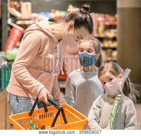 Mom And Kids Are Shopping At The Grocery Store.