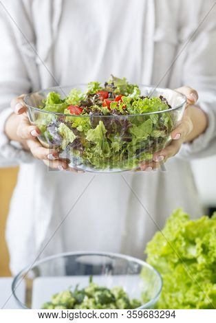 Healthy Nutrition Concept. Unrecognizable Woman Preparing A Green Mixed Salad In The Kitchen, Vertic