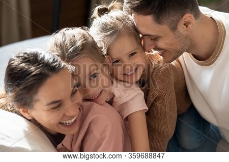 Affectionate Family Of Four Enjoying Sweet Tender Weekend Moment.