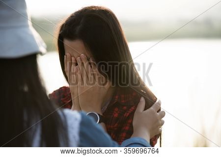Close Up Of Crying Girl, Who Covers Her Face With Both Hands. Woman Comforting Crying Girl, Comfort 