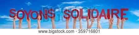 People Hands Holding Word Soyons Solidaire Means Showing Solidarity, Blue Sky