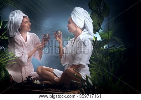Portrait Of Young Beautiful Women Drinking Tea  In Spa Environment.