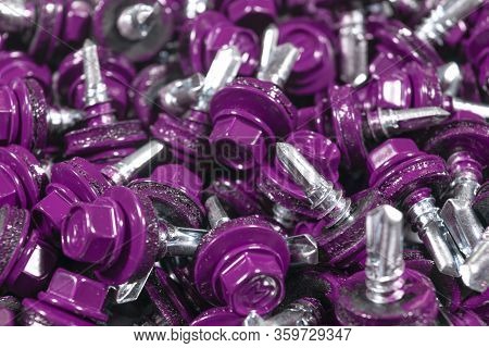 Top View Of Roofing Screws Background Texture. Red Roofing Screws Background. А Bunch Of Self-tappin