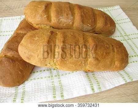 Freshly Baked Spelt Baguette On A Dishtowel
