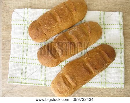 Freshly Baked Spelt Baguette On A Dishtowel