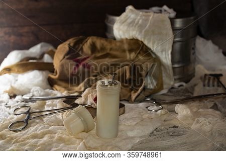 Retro Syringe, And Medical Surgical Instrument On A Wooden Table. Vintage Style.
