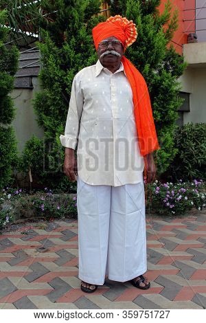 Kolhapur, Maharashtra/ India- December 12th 2019; Old Indian Grandfather Wearing Orange Color Turban