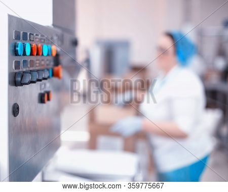 Control Panel Of An Automatic Line In Production. Woman Worker Packs Products At The Factory. Indust