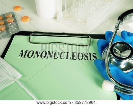 Mononucleosis Diagnosis On The Green Sheet And Gloves.