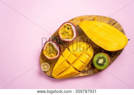 Healthy Vegan Breakfast Of Raw Fruits. Closeup Of Sliced Fresh Mango, Kiwi, Passion Fruit, Longan On