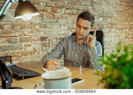 Talking On Phone. Man Working From Home During Coronavirus Or Covid-19 Quarantine, Remote Office Con