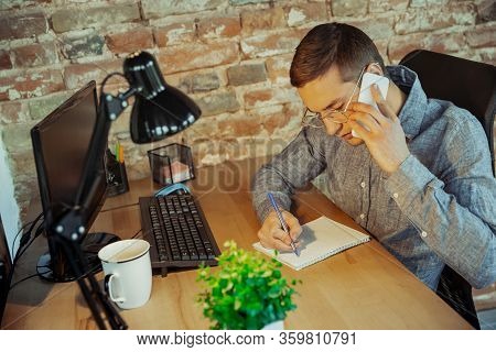 Talking On Phone. Man Working From Home During Coronavirus Or Covid-19 Quarantine, Remote Office Con