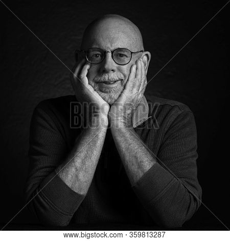 Artistic Studio Portrait Headshop Of A Cheeerful Senior In Black And White.