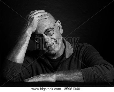 Artistic Studio Portrait Headshop Of A Cheeerful Senior In Black And White.