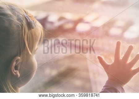 Girl Looks Lonely Through Window By Putting Her Hands On Window Sill