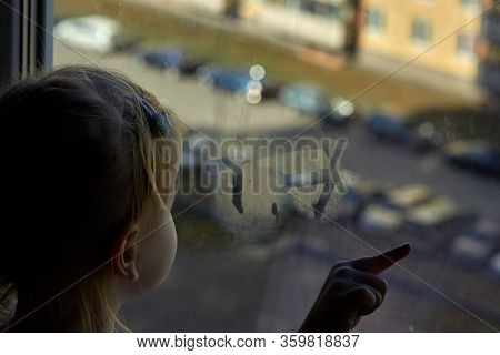 Girl Looks Lonely Through Window By Putting Her Hands On Window Sill