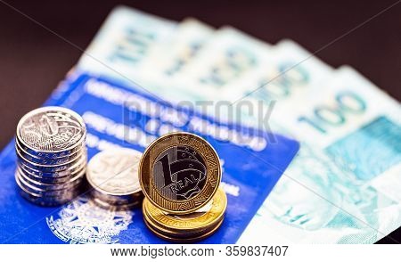 Old Work Card From Brazil, Old And Handled Document. Beside Real Coins, Brazilian Money. Concept Of