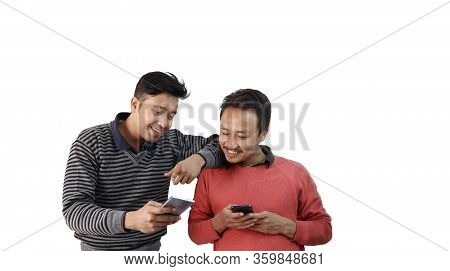 Two Different Ethnic Men Talking And Smiling With Mobile Phone In Hand Isolated In White Background