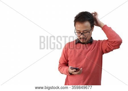 A Man Looking At His Phone Confused And Scratching His Head In Confused Expression Isolated In White