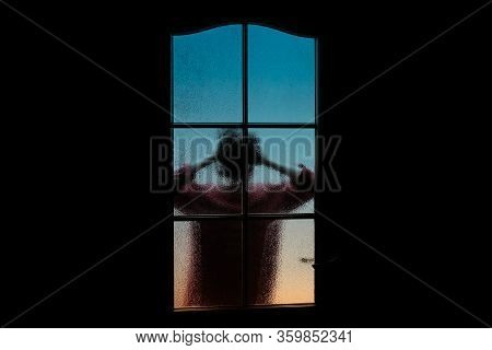 Dark Silhouette Of Girl Alone In Isolation On Light Background Behind Closed Glass Door. Abstract Im