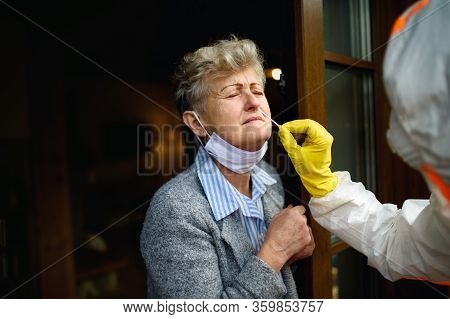 Taking Corona Virus Test Sample From Nose Of Senior Woman, Quarantine Concept.