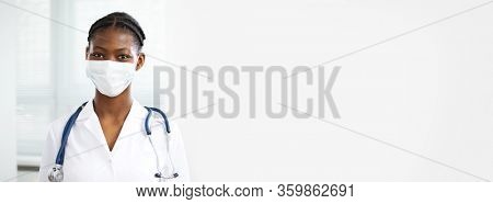 ?lose-up face of smiling young africanamerican female doctor ?n a background for your text.