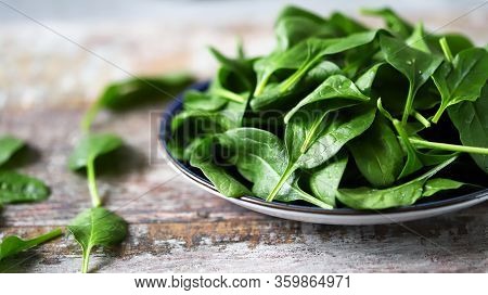 Fresh Baby Spinach On A Plate. Juicy Spinach Leaves. Diet Concept. Vegan Food.