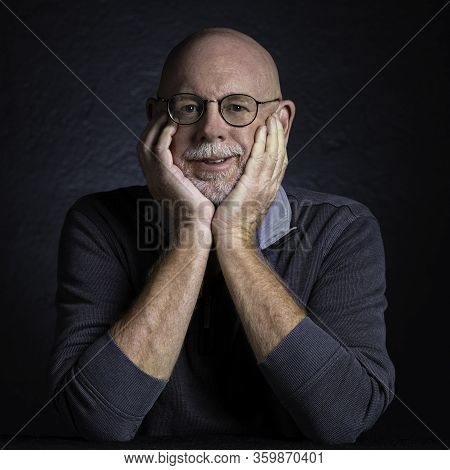 Artistic Studio Portrait Headshop Of A Cheeerful Senior In Black And White.