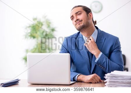 Young male businessman working in the office