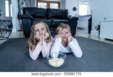 Coronavirus Lockdow. Bored Little Girl And Sad Boy Watching Tv In Isolation At Home During Quarantin