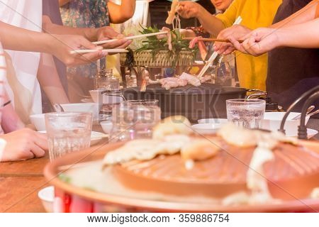 Family Dinner Hand With Chopstick Cooking Praw On Hot Bbq Pan