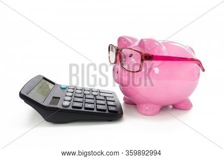 Piggy bank with eye glasses  and calculator concept for saving, accounting, banking and business account