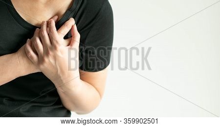 Close-up Of A Woman Pressing On Left Chest With Painful On White Background With Copy Space. The Con