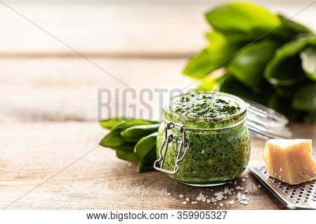 Wild Leek Pesto With Olive Oil And Parmesan Cheese In A Glass Jar On A Wooden Table. Useful Properti