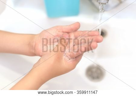Washing Your Hands Of Viruses And Bacteria Under The Tap With Soap. Personal Hygiene