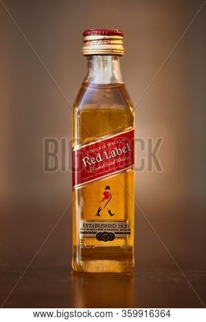 BUDAPEST, HUNGARY - CIRCA 2019: Johnnie Walker whisky on a table in a small bottle of 50 ml from hotel minibar