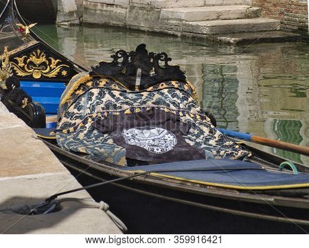 Detail Of Venetian Gondola In Green Canal Waters Of Venice Italy