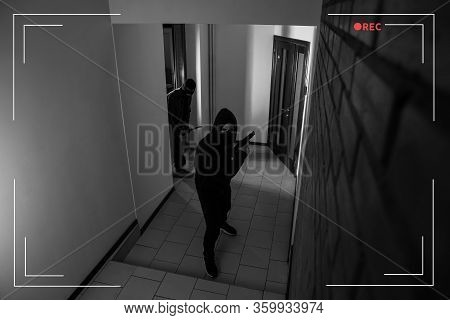 Dangerous Criminals In Masks With Weapon In Hallway, View Through Cctv Camera