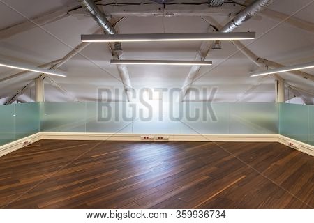 Attic Room With Laminate Floor After The Reconstruction Of The Old House. Design Solution For The Eq