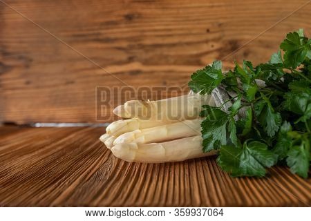 White Asparagus With Fresh Parsley On Rustic Wooden Background. Close Up Photography With Space For 