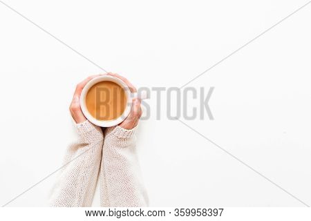 Female Hands Holding Cups Of Coffee On White Table Background