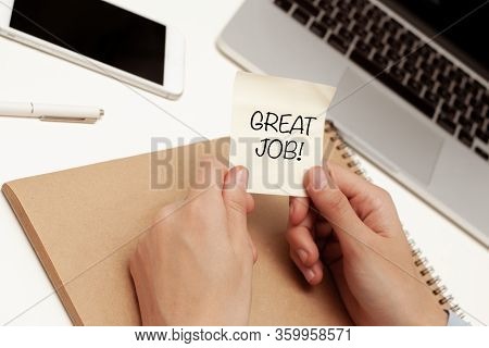 The Inscription Work At Home, Against The Background Of A Hand Writing In A Notebook Holding A Cup O